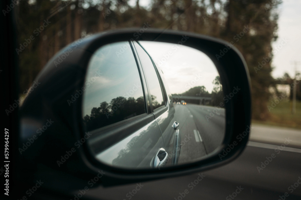Reflection of car on road seen in side-view mirror Reflection of car on road seen in side-view mirror