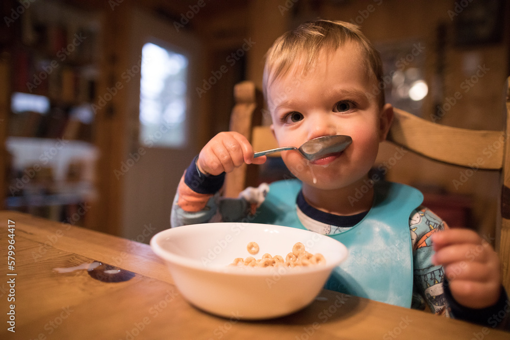 Portrait of cute baby boy eating breakfast while sitting at home Portrait of cute baby boy eating breakfast while sitting at home