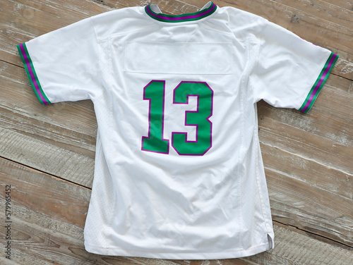 High angle view of t-shirt with number 13 on wooden table photo