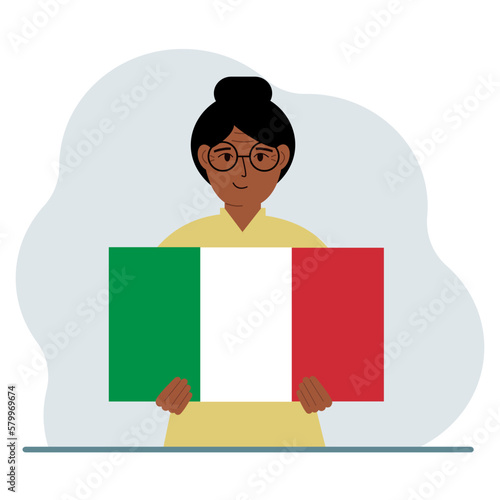 A woman holds an Italian flag in his hands. The concept of demonstration, national holiday or patriotism.