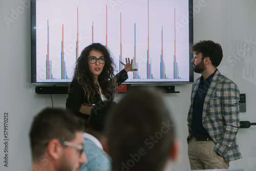 Business woman is presenting something toher colleagues photo