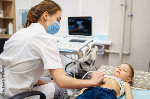 Fotografía Doctor conducts an ultrasound examination of the heart and abdominal organs of a little boy using modern medical equipment in a clinic