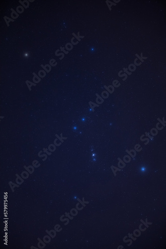 Orion constellation and starry Milky Way skies photographed with wide angle lens.