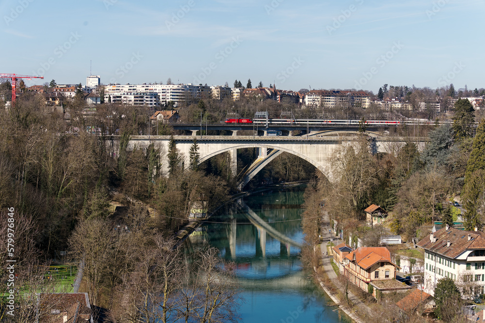 Bridges over Aare River with train crossing at Swiss City of Bern on a sunny winter day. Photo taken February 21st, 2023, Bern, Switzerland.
