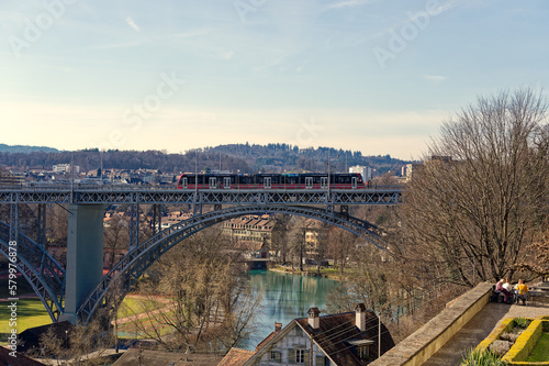 Scenic view over City of Bern with Matte district, old town, Aare River and Church Field Bridge with tram crossing on a sunny winter day. Photo taken February 21st, 2023, Bern, Switzerland.