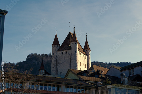 Old town of City of Thun with white castle on a hill in the background on a sunny winter day. Photo taken February 21st, 2023, Thun, Switzerland. © Michael Derrer Fuchs