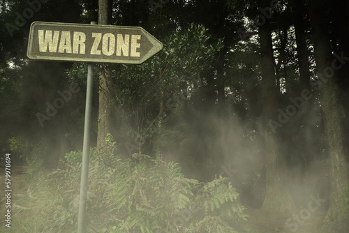 Canvas Print old signboard with text war zone near the green sinister forest