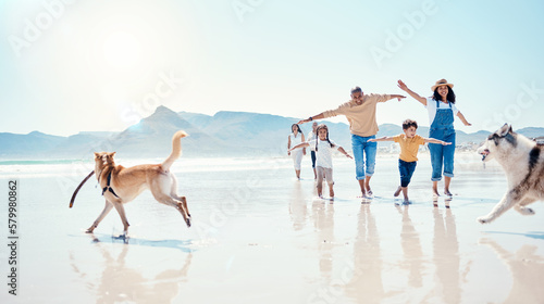 Family, beach and parents with children and dogs for bonding, quality time and adventure together. Travel, pets and happy mom, dad and kids enjoy summer holiday, vacation and relax on weekend by sea #579980862