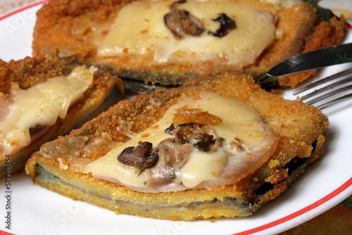 Delicious eggplant cutlets with cooked ham, melted cheese and mushrooms.