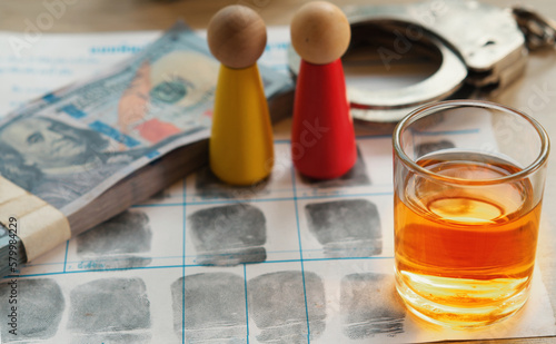 Alcohol laws regulate the sale, possession, and use of alcoholic beverages, opening/closing times for bars, and restrictions on public intoxication. Glass of whiskey on fingerprint crime page file.