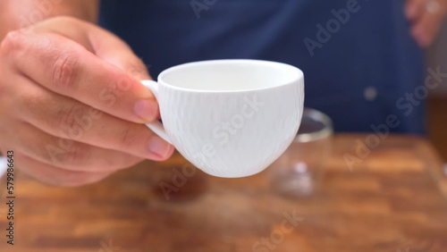 coffee cup in the hand of a barista