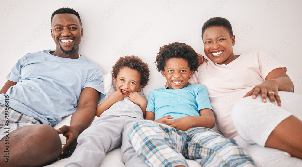 Black family, smile and portrait of parents with children on bed for bonding, quality time and relax together. Love, happy and African mom, dad and kids in bedroom enjoy morning, weekend and holiday