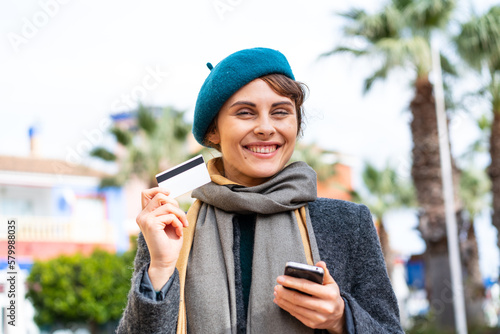 Brunette woman at outdoors making a selfie with mobile phone © luismolinero