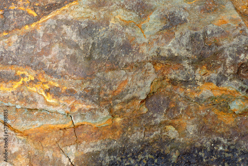 A brown and orange sedimentary rock containing sulfur and pyrite