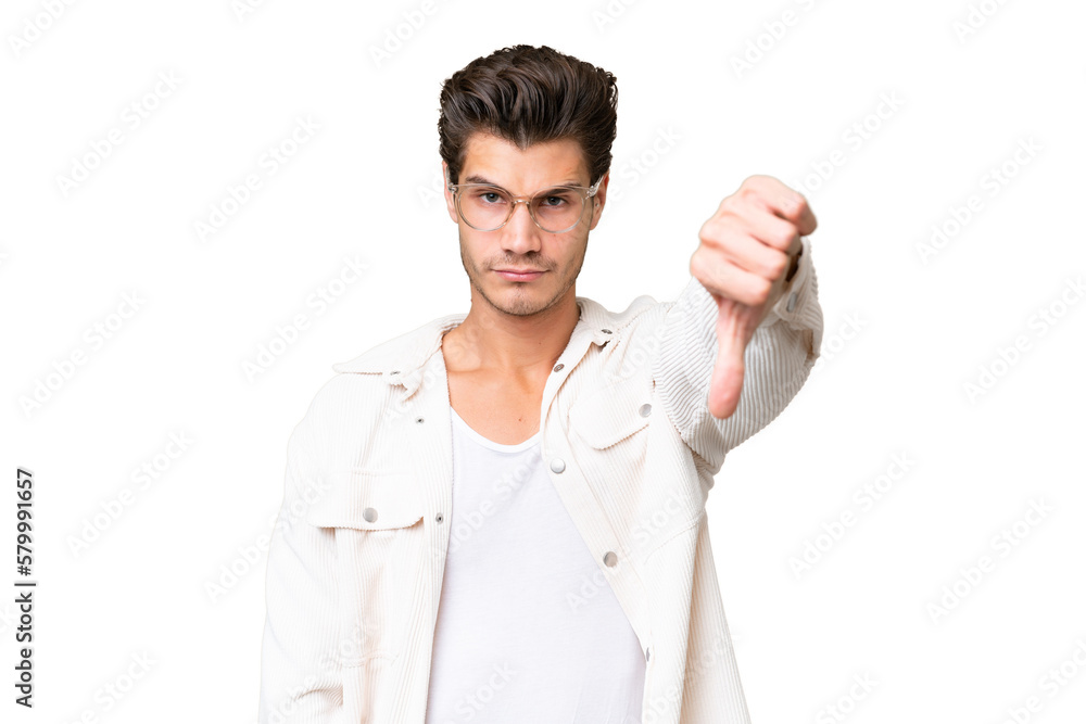 Young handsome caucasian man over isolated background showing thumb down with negative expression Young handsome caucasian man over isolated background showing thumb down with negative expression