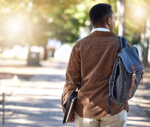 Fotografie Black man, walking or backpack on campus, park nature or garden for college, university or school studying development