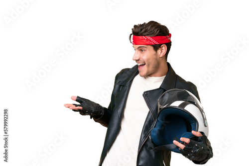 Young caucasian man with a motorcycle helmet over isolated background with surprise expression while looking side