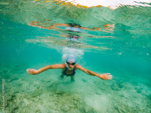 woman snorkeling in clear tropical sea © Melinda Nagy