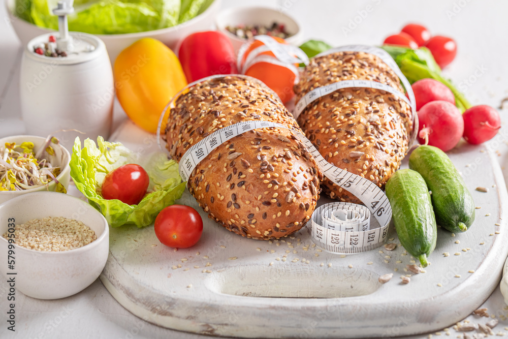 Tasty ingredients for sandwich with measure tape. Tasty ingredients for sandwich with measure tape.