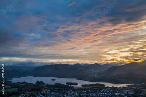 Absolutely wonderful landscape image of view across Derwentwater from Latrigg Fell in lake District during Winter beautiful colorful sunset