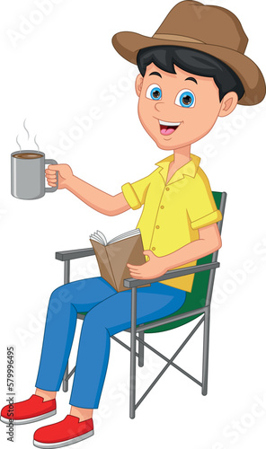boy reading book and holding hot drink