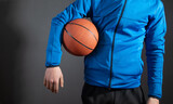 Caucasian man holding basketball ball.