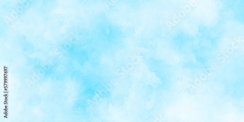 Beautiful and cloudy sky blue watercolor background, blurred and grainy Blue powder explosion on white background, Classic hand painted Blue watercolor background for design. 