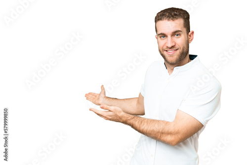 Young handsome blonde man over isolated chroma key background extending hands to the side for inviting to come