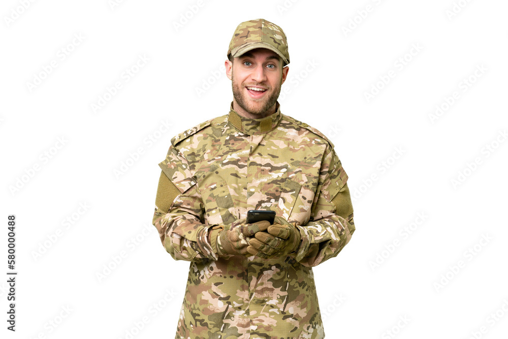 Military man over isolated chroma key background surprised and sending a message Military man over isolated chroma key background surprised and sending a message
