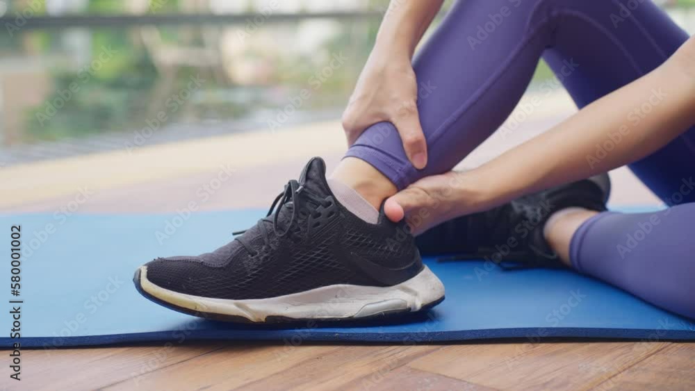 Woman athlete doing leg massage after workout. ankle pain. Painful