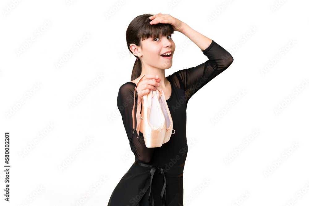 Little caucasian girl practicing ballet over isolated background doing surprise gesture while looking to the side