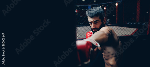 MMA fighter trains with punching bag in gym, dark background banner