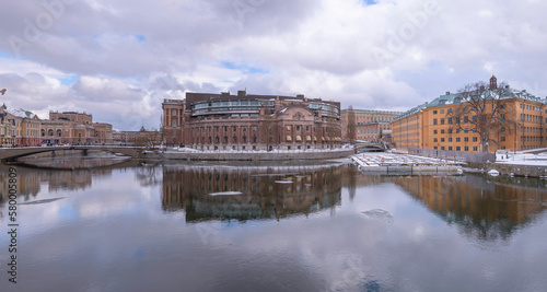 The canals Stallkanalen and Strömmen, the Parliament and government buildings, a grey snowy day in Stockholm