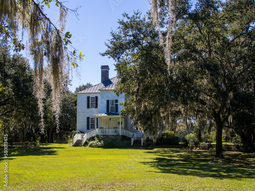 Принти на полотні Hopsewee Plantation, Georgetown, near Myrtle Beach in South Carolina, framed by trees with Spanish moss and a clear blue sky