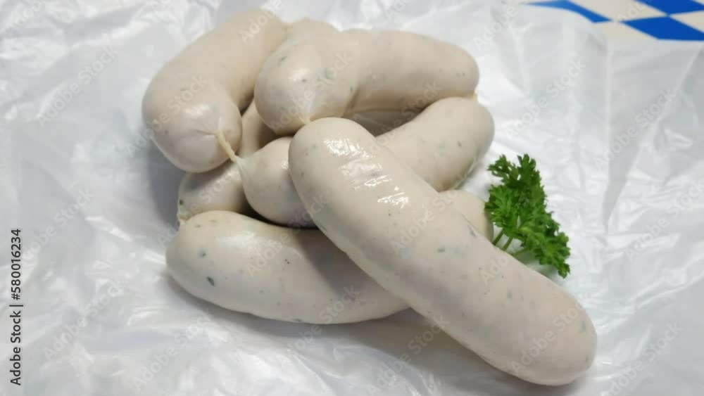 Pile of munich white sausage on white paper, spinning video Pile of munich white sausage on white paper, spinning video
