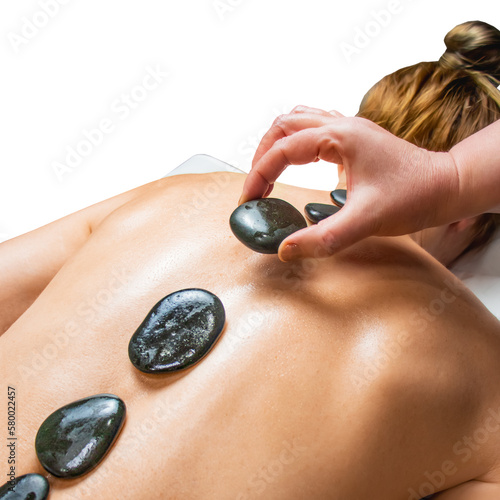 Stone therapy, top view of young woman getting hot stone massage in spa salon, 