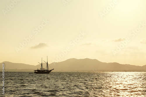 Sunset seascape. Ship sailing the sea. © luengo_ua