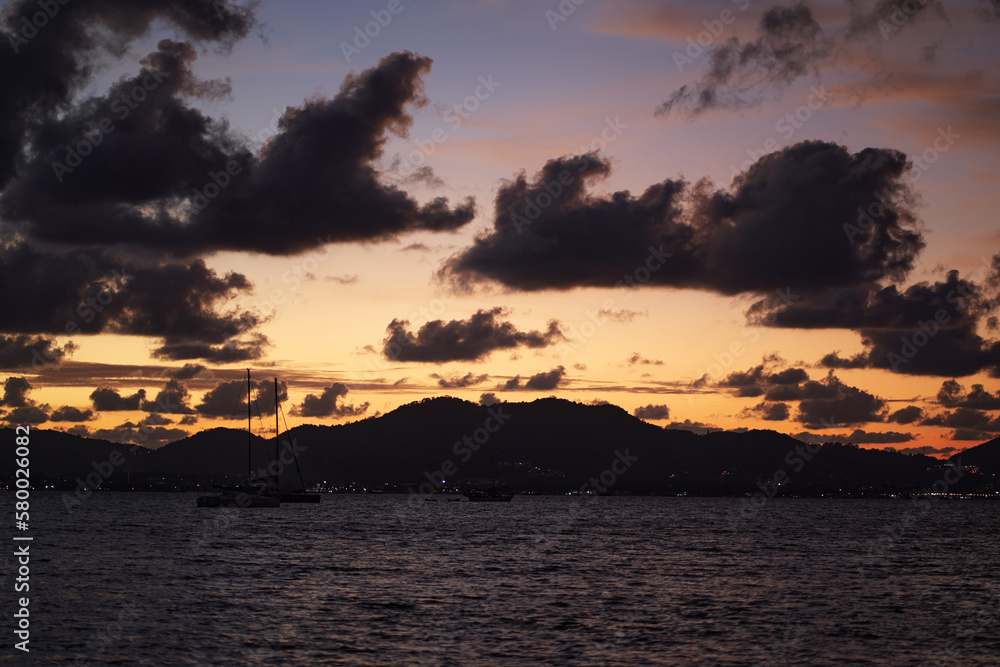 Dramatic landscape with sunset on the sea shore. Beautiful cloudy sky. Dramatic landscape with sunset on the sea shore. Beautiful cloudy sky.