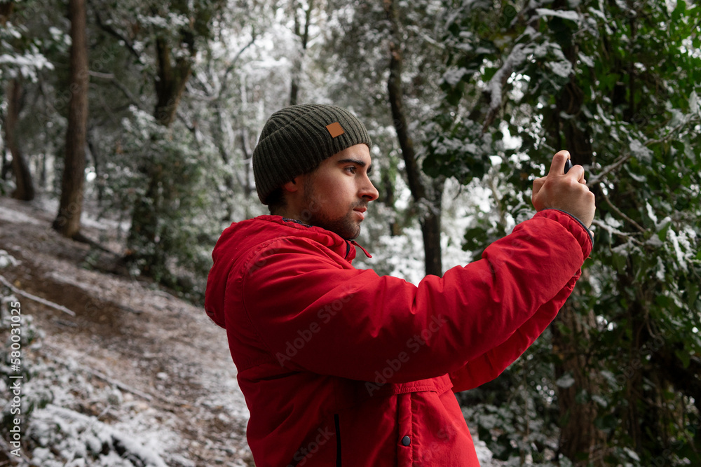Man in cap taking pictures with smartphone Man in cap taking pictures with smartphone