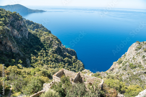 Mediterranean coastline near Kayakoy village in Mugla province of Turkey, with ruins of Afkule monastery.