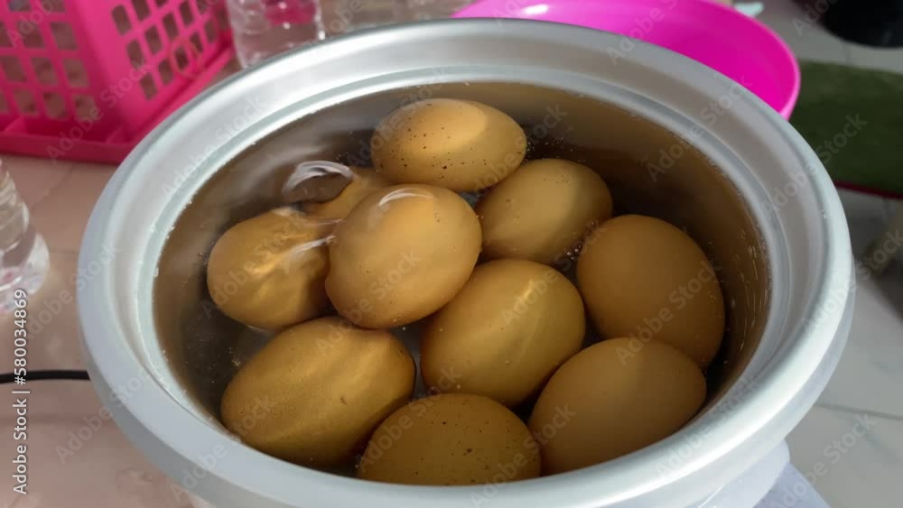 Farm fresh organic chicken eggs in boiling water in pot at kitchen close up shot Farm fresh organic chicken eggs in boiling water in pot at kitchen close up shot