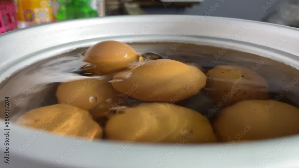 Farm fresh organic chicken eggs in boiling water in pot at kitchen close up shot Farm fresh organic chicken eggs in boiling water in pot at kitchen close up shot