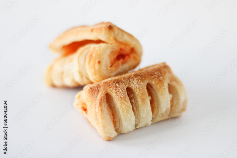 Bakery pastries with ham and cheese close-up. The concept of a delicious breakfast. Isolated over white background Bakery pastries with ham and cheese close-up. The concept of a delicious breakfast. Isolated over white background