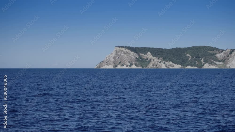 Sailing along cape of Corfu island in Greece on trip to caves on Paxos island Sailing along cape of Corfu island in Greece on trip to caves on Paxos island