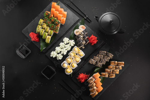 sushi set on the black background. sushi and fish rolls