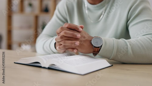 Closeup, bible and hands with man praying, religion and spiritual guidance with hope, help or worship Jesus Christ. Zoom, religious scripture or believer with faith, Catholic text or prayer for peace