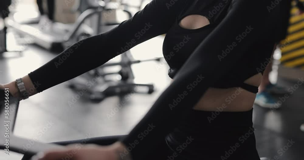 Woman exercising at gym on the training apparatus Woman exercising at gym on the training apparatus