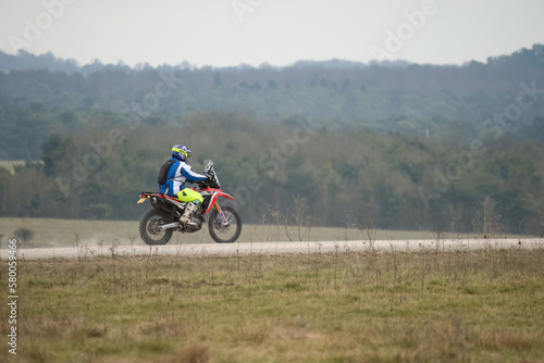 a motor cyclist  biker  riding his off-road motorbike along a stone track on Salisbury Plain  Wiltshire