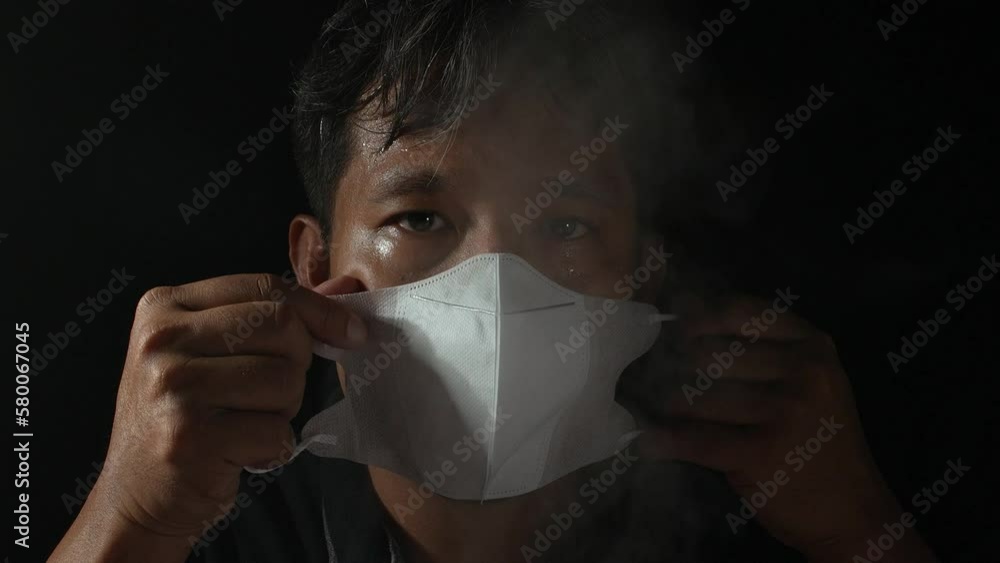 Smoke air pollution with health and environmental impacts concept. A man wearing mask protective air smog pollution with PM 2.5, Thailand. Smoke air pollution with health and environmental impacts concept. A man wearing mask protective air smog pollution with PM 2.5, Thailand.