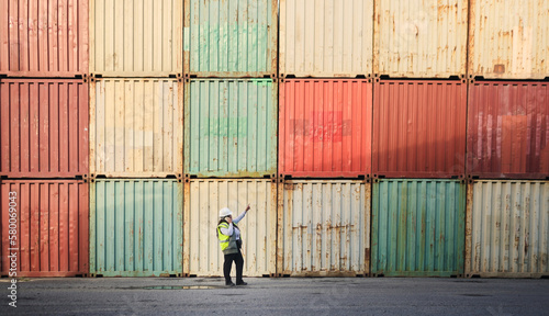 Logistics, shipping yard and cargo containers manager woman talking on phone for communication for import and export at a shipyard. Female engineer and supply chain worker at a port in South African